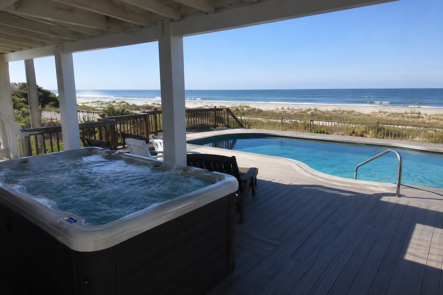 Oceanfront pool deck with hot tub overlooking the beach